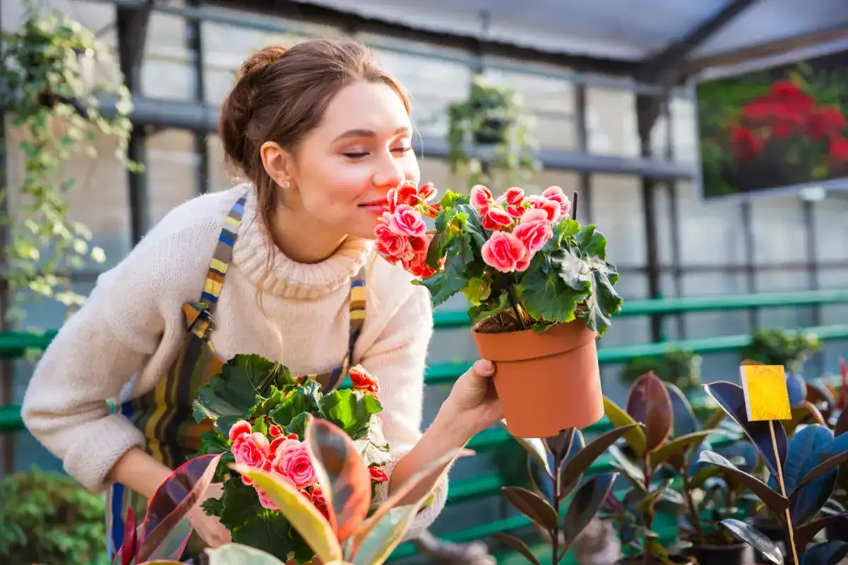 girl smelling flowers at a flower shop