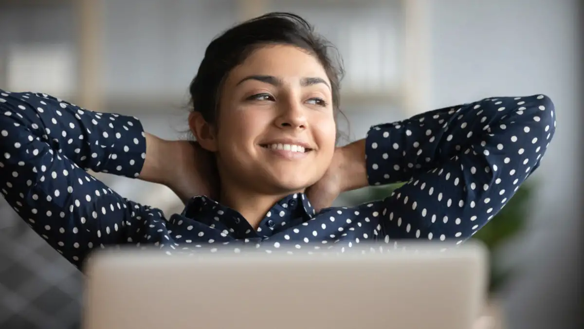smiling woman in front of computer