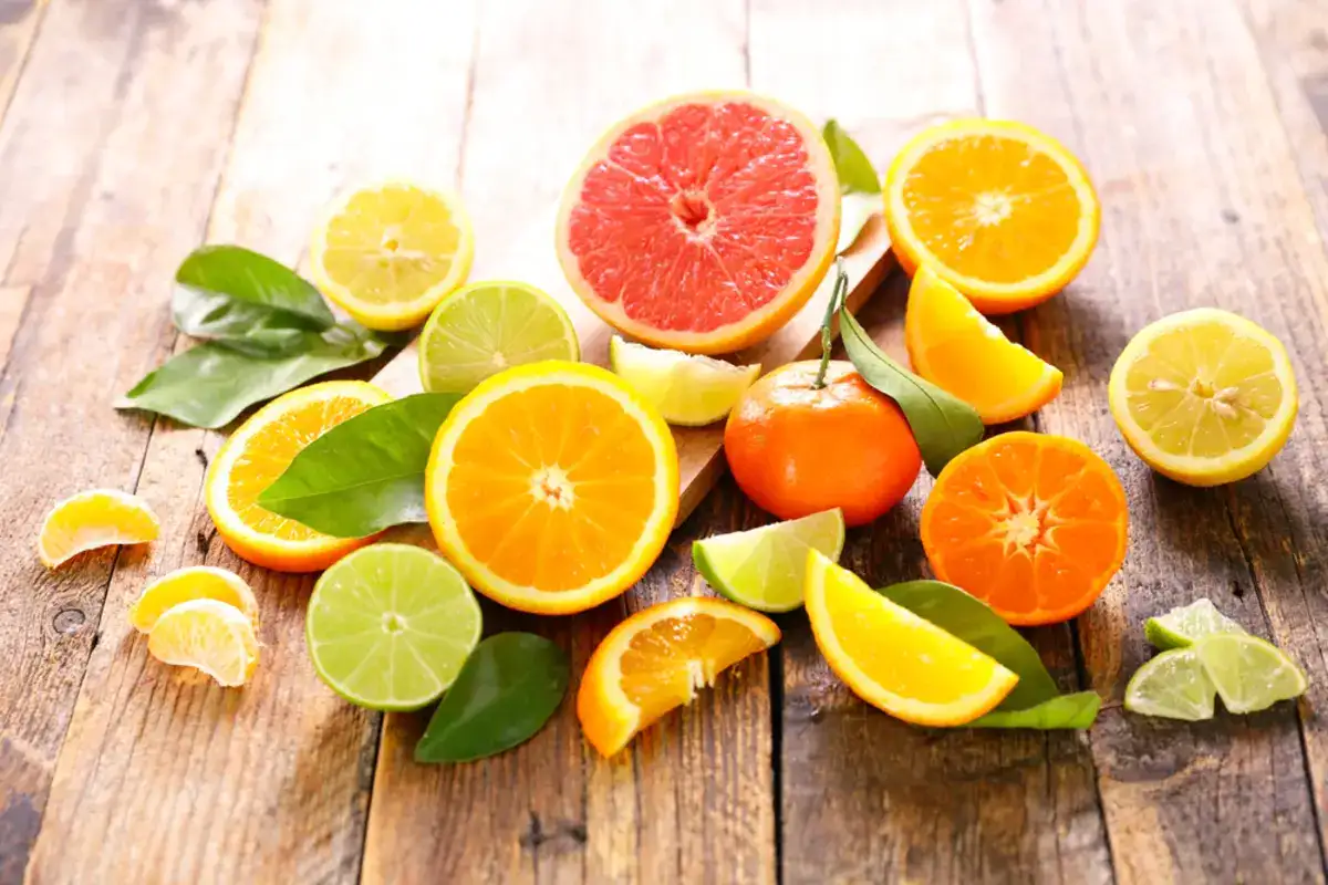 Citrus fruits and leaves on a wooden table