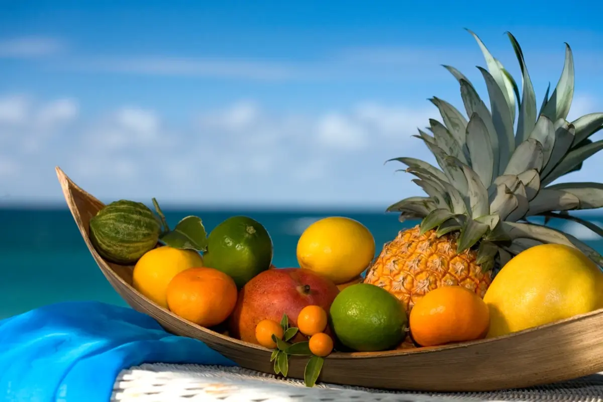 Wooden boat filled with fruit on a beach