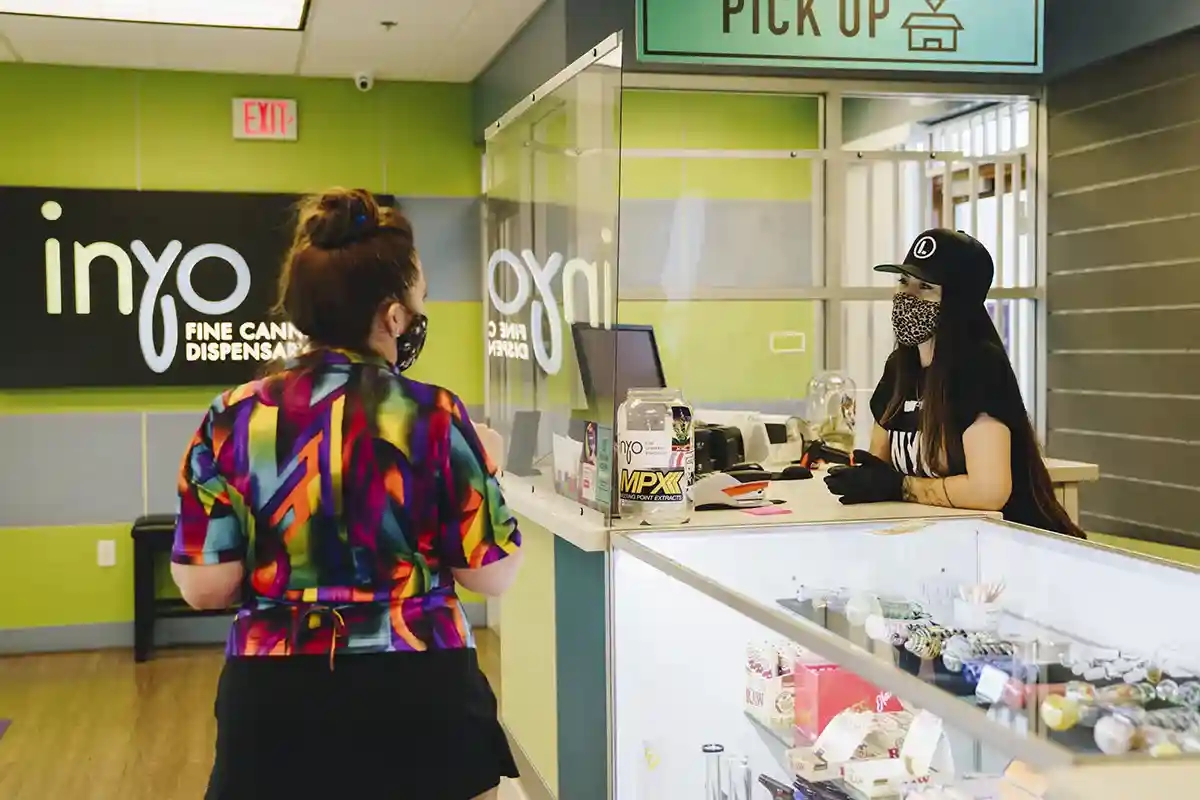 Woman buying cannabis products at INYO