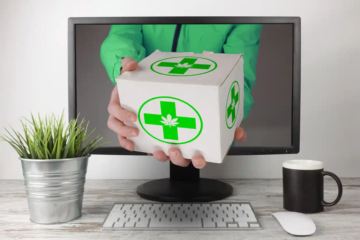 A deliveryman delivering a medical marijuana box online through a computer screen