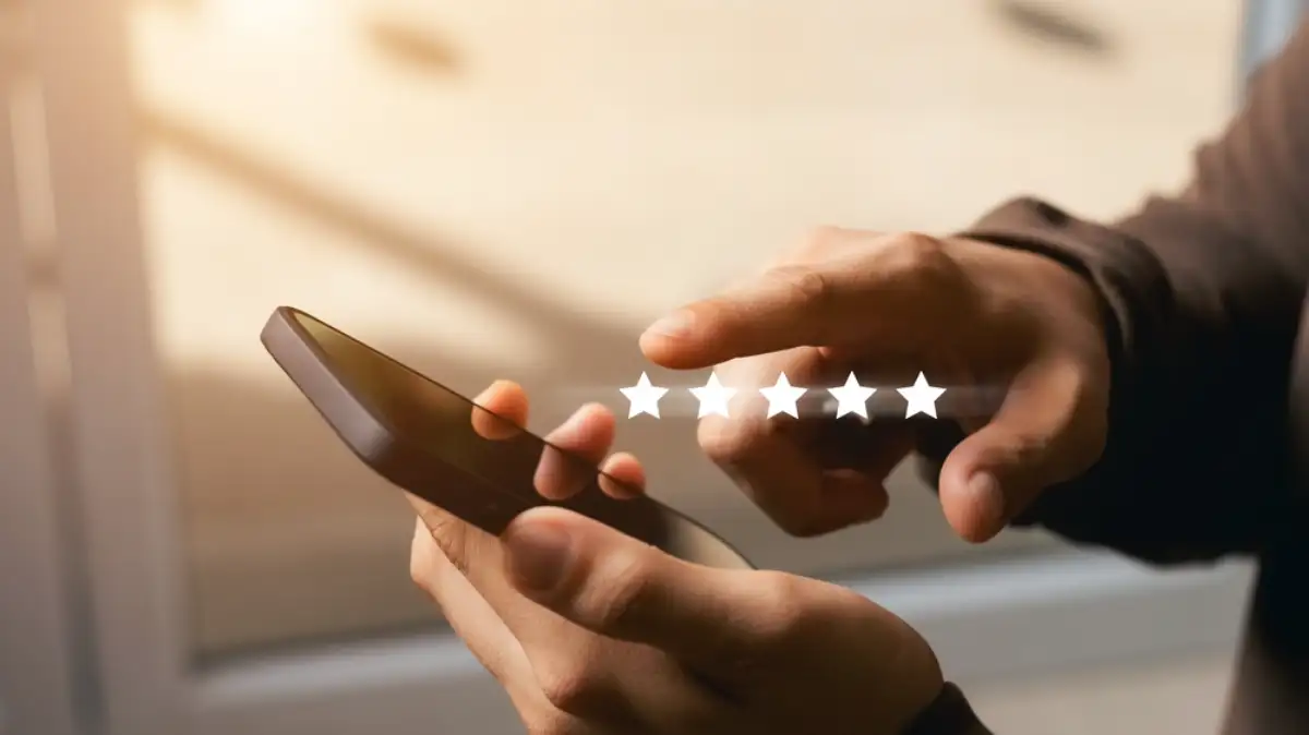 Male customer gives a five-star rating on their smartphone