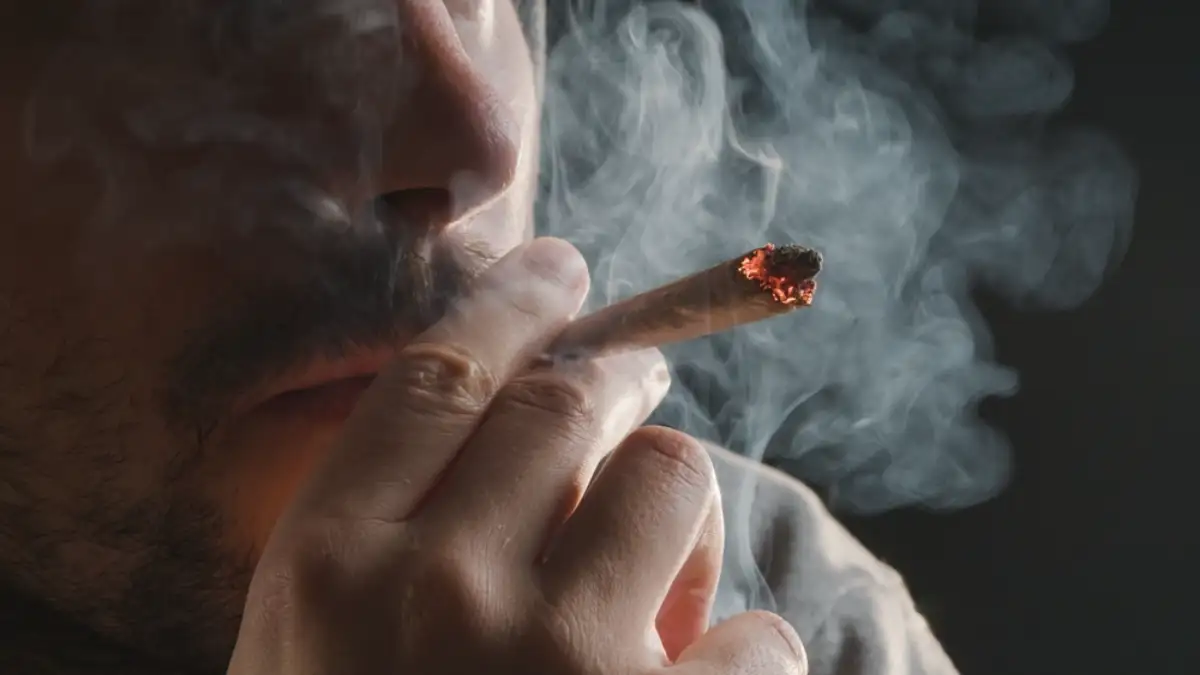 Man smoking a marijuana weed joint