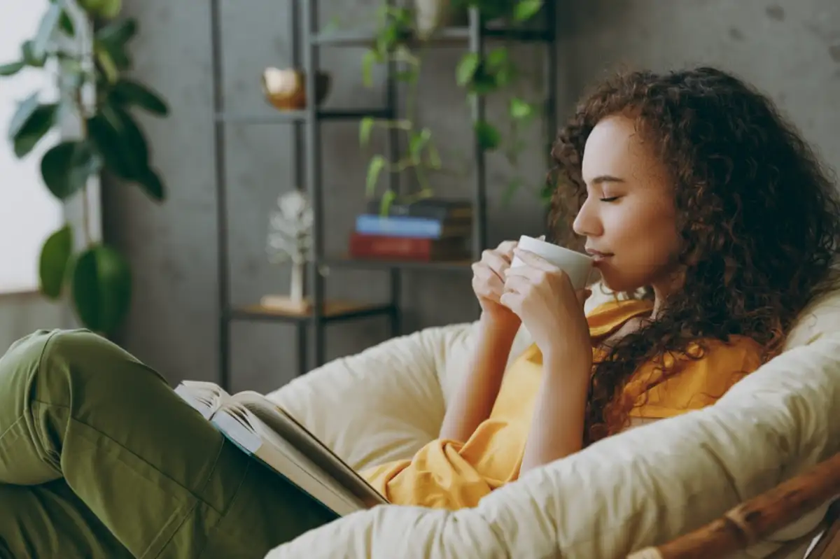Woman relaxing while drinking coffee