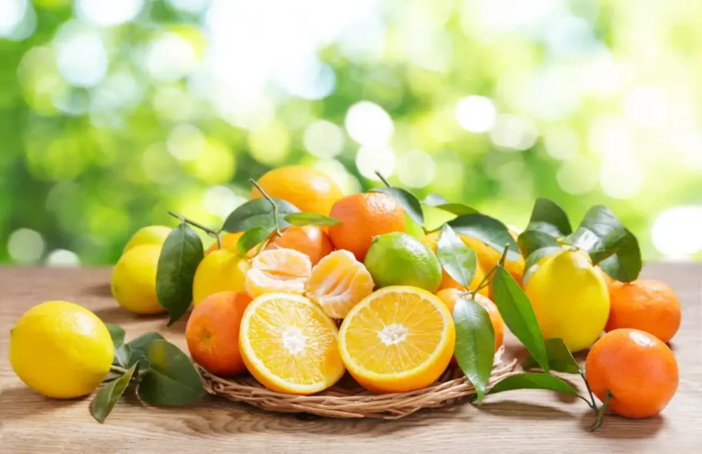 fresh citrus fruits with leaves on a wooden table