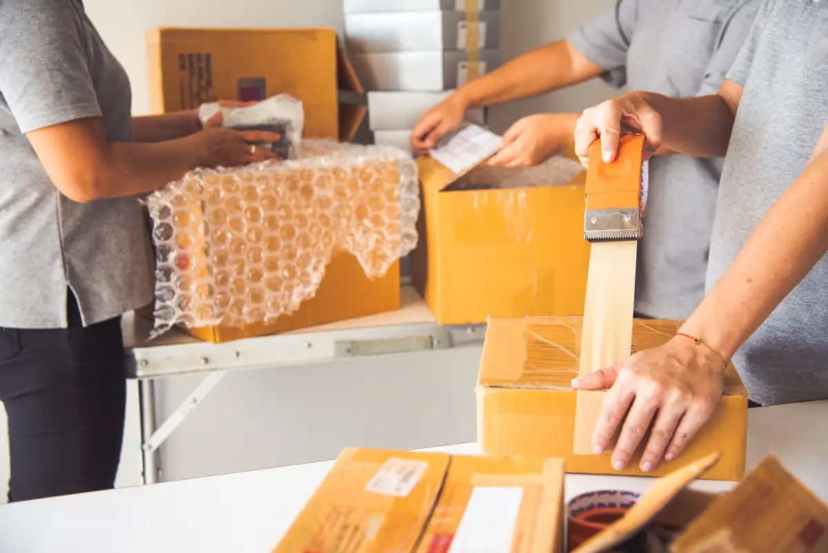 Man and a woman packing boxes