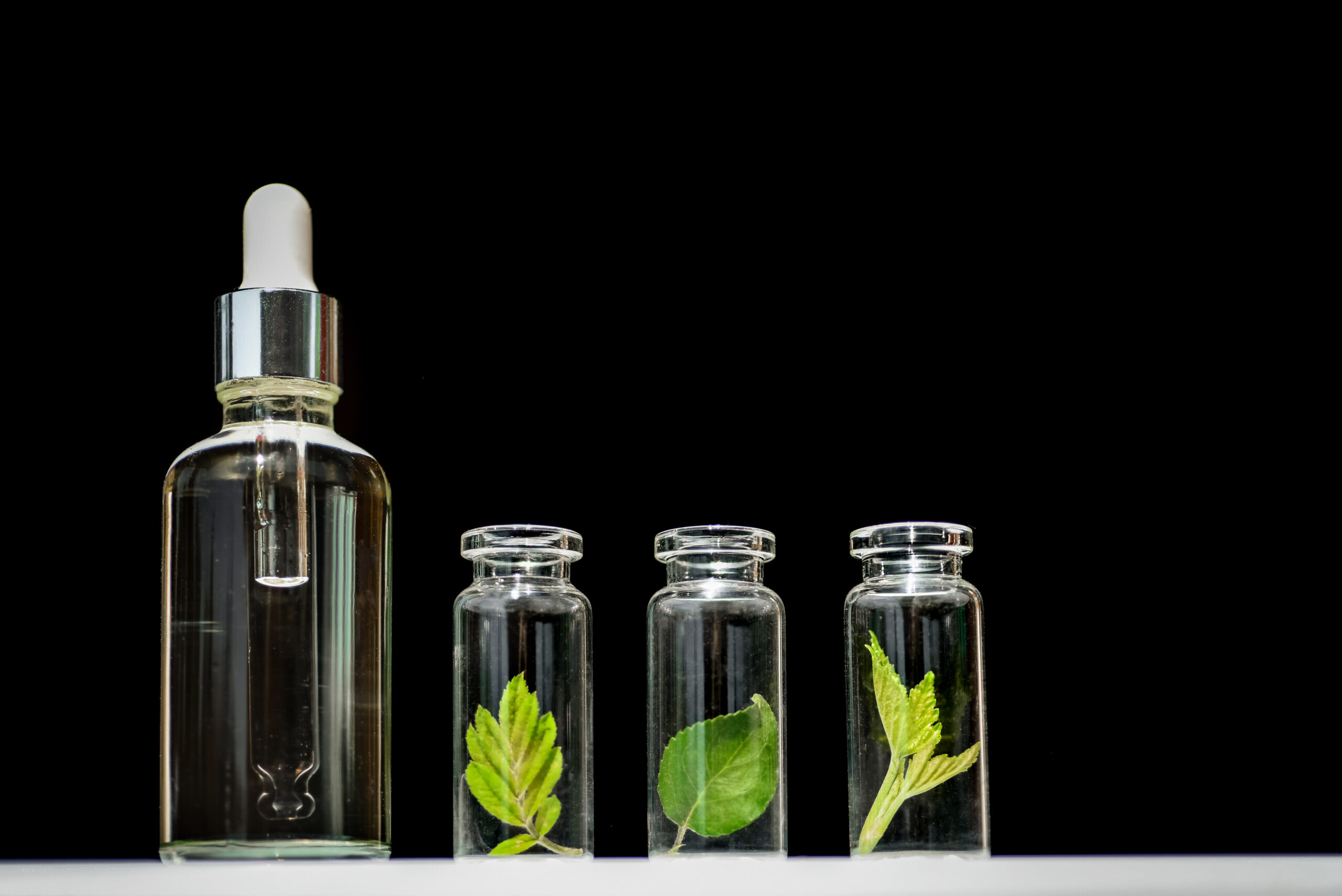homeopathic-oil-serum-and-bottles-with-plants