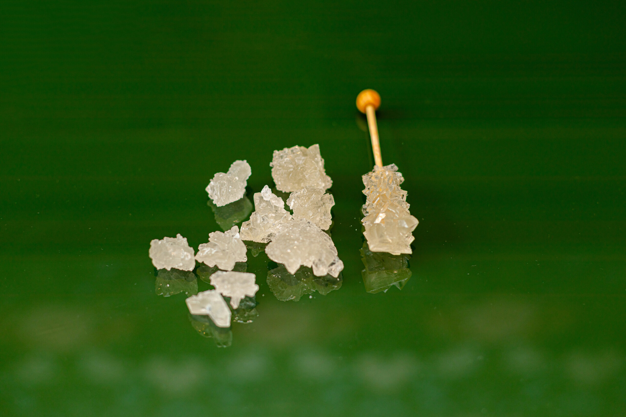 rock-candies-stick-laying-on-the-green-background