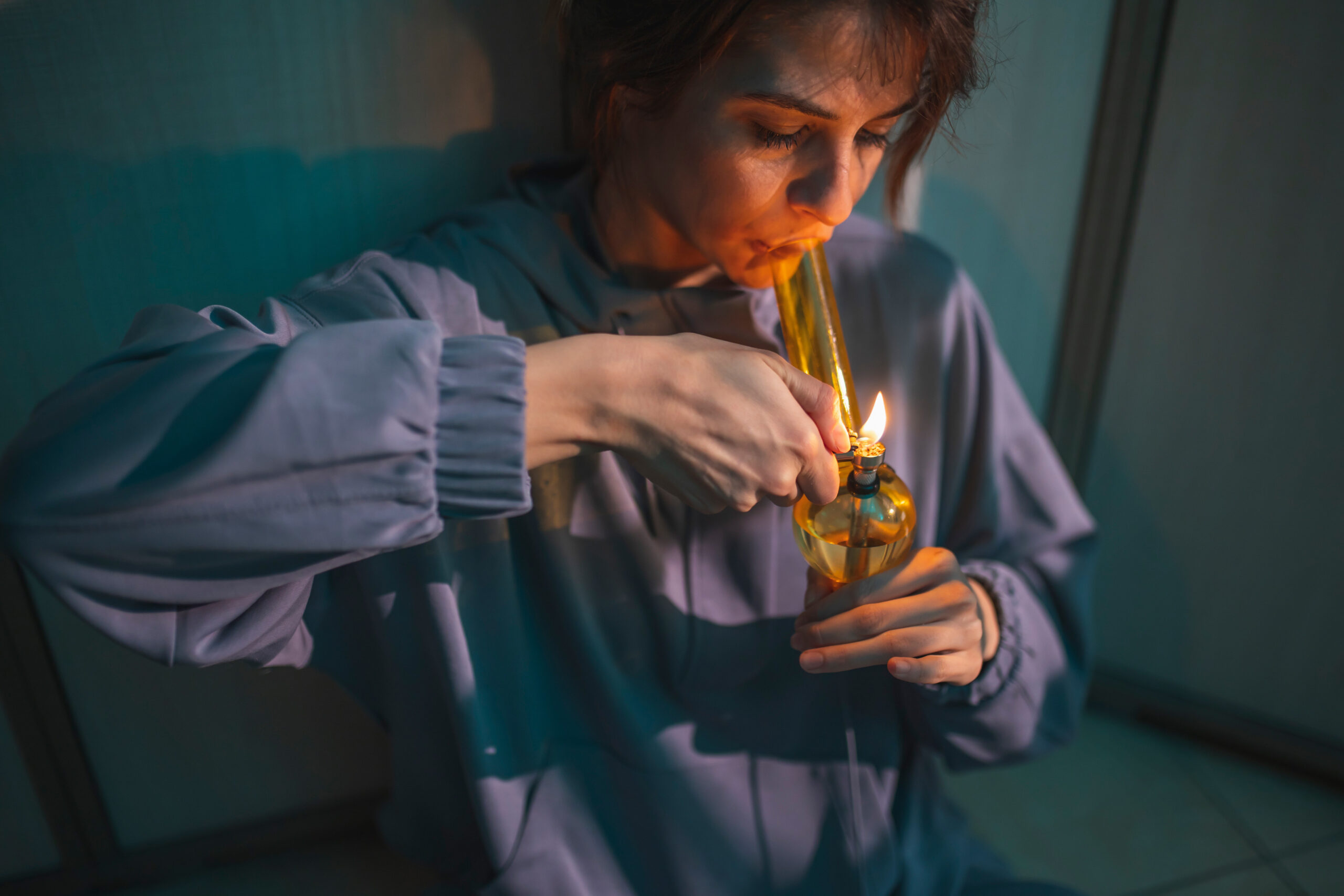 woman-using-bong-smoking-pot