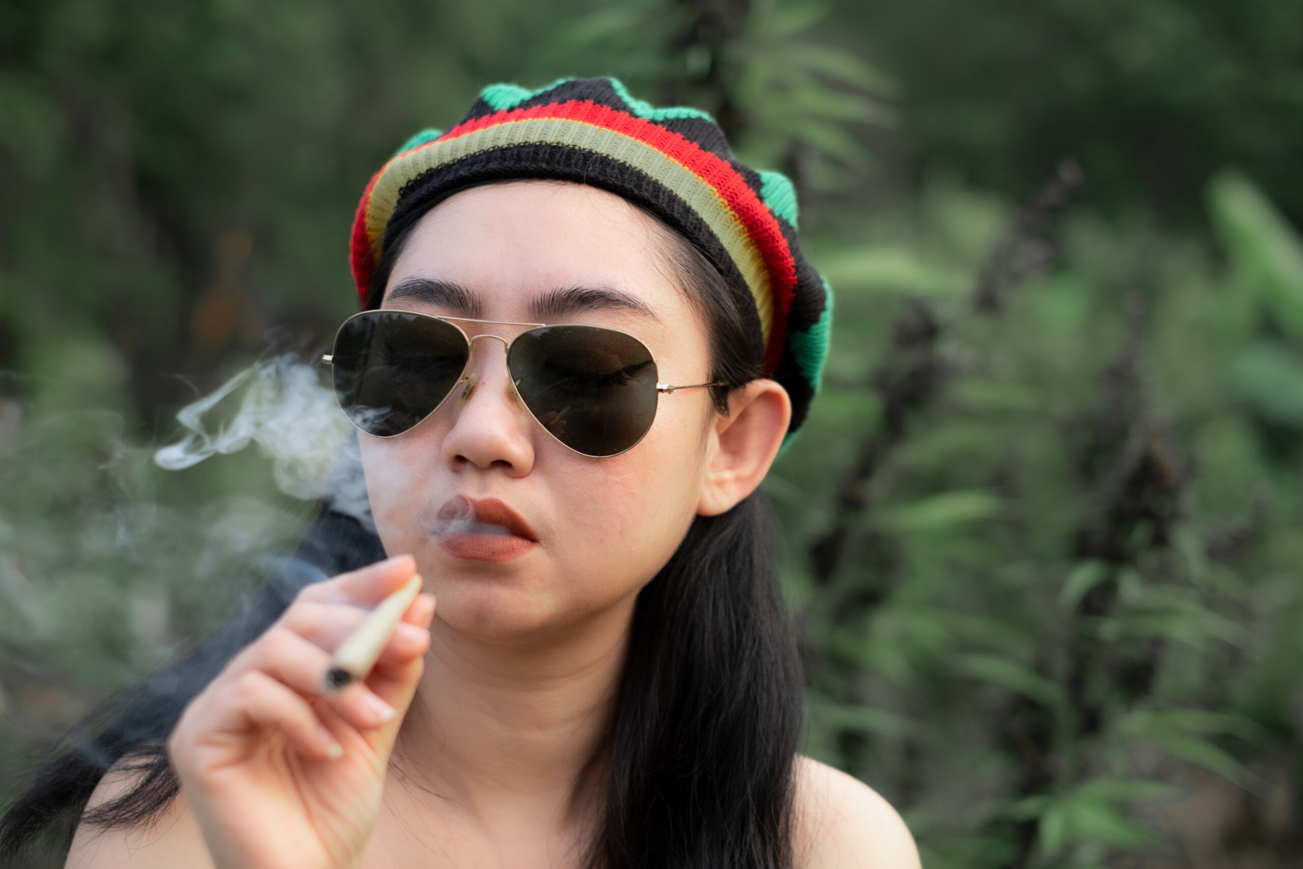 yong-asia-woman-smoking-marijuana-at-cannabis-tree